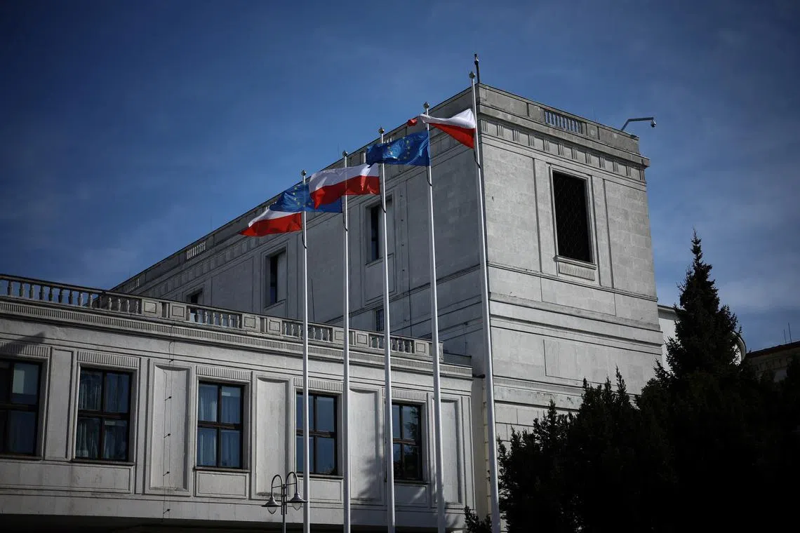Polish and European Union flags are seen in front of the Polish Parliament building in Warsaw, Poland, March 5, 2025. REUTERS/Kacper Pempel/File Photo