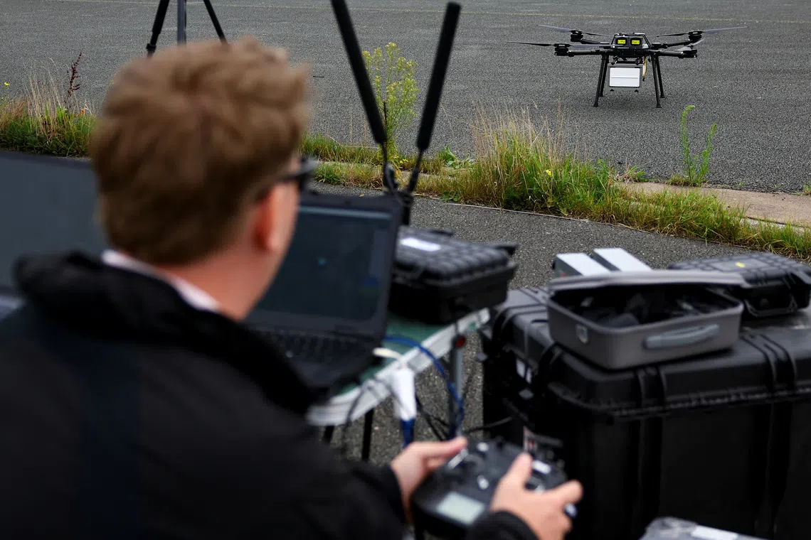 An engineer tests commands on the AI-powered Nexus system during flight tests with multiple drones in Katwijk aan Zee, Netherlands, September 30, 2026. REUTERS/Piroschka van de Wouw