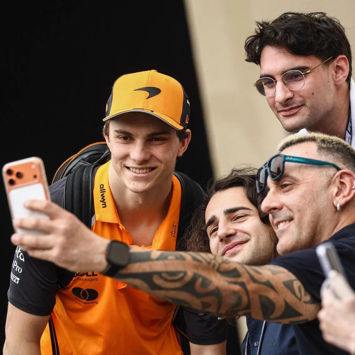 McLaren’s Oscar Piastri posing for a wefie  with fans ahead of the Abu Dhabi GP.