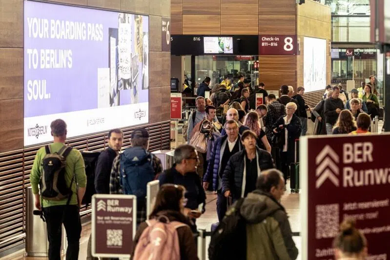 Passengers queue at check-in desks, after a cyberattack caused an outage to key airline check-in systems, at Berlin Brandenburg Airport in Berlin, Germany, on Sept 22, 2025.