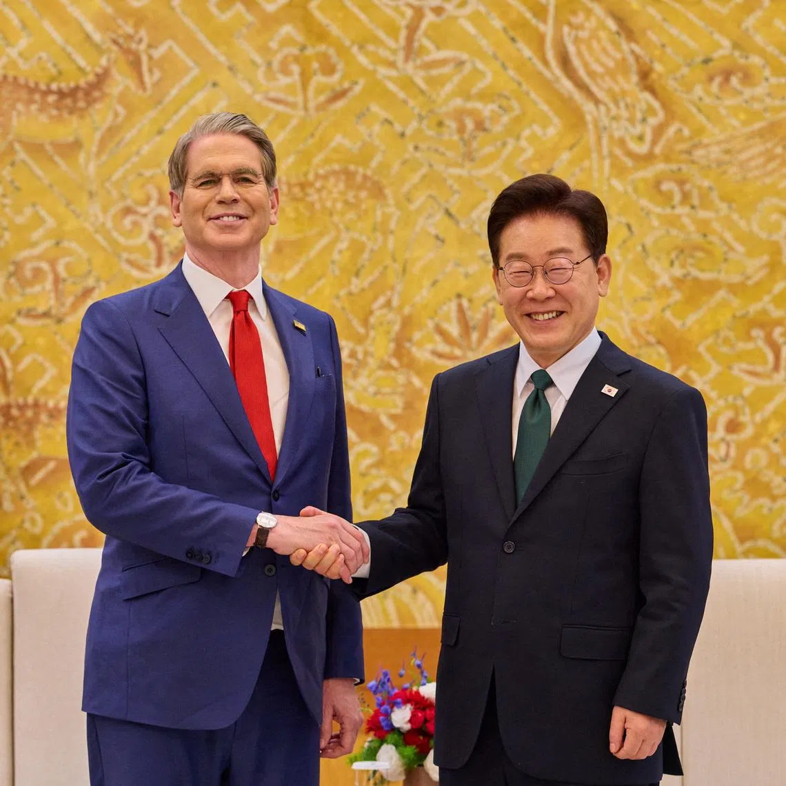 South Korean President Lee Jae Myung shakes hands with U.S. Treasury Secretary Scott Bessent during their meeting at the Presidential Blue House in Seoul, South Korea, May 13, 2026.    The Presidential Blue House/Yonhap via REUTERS