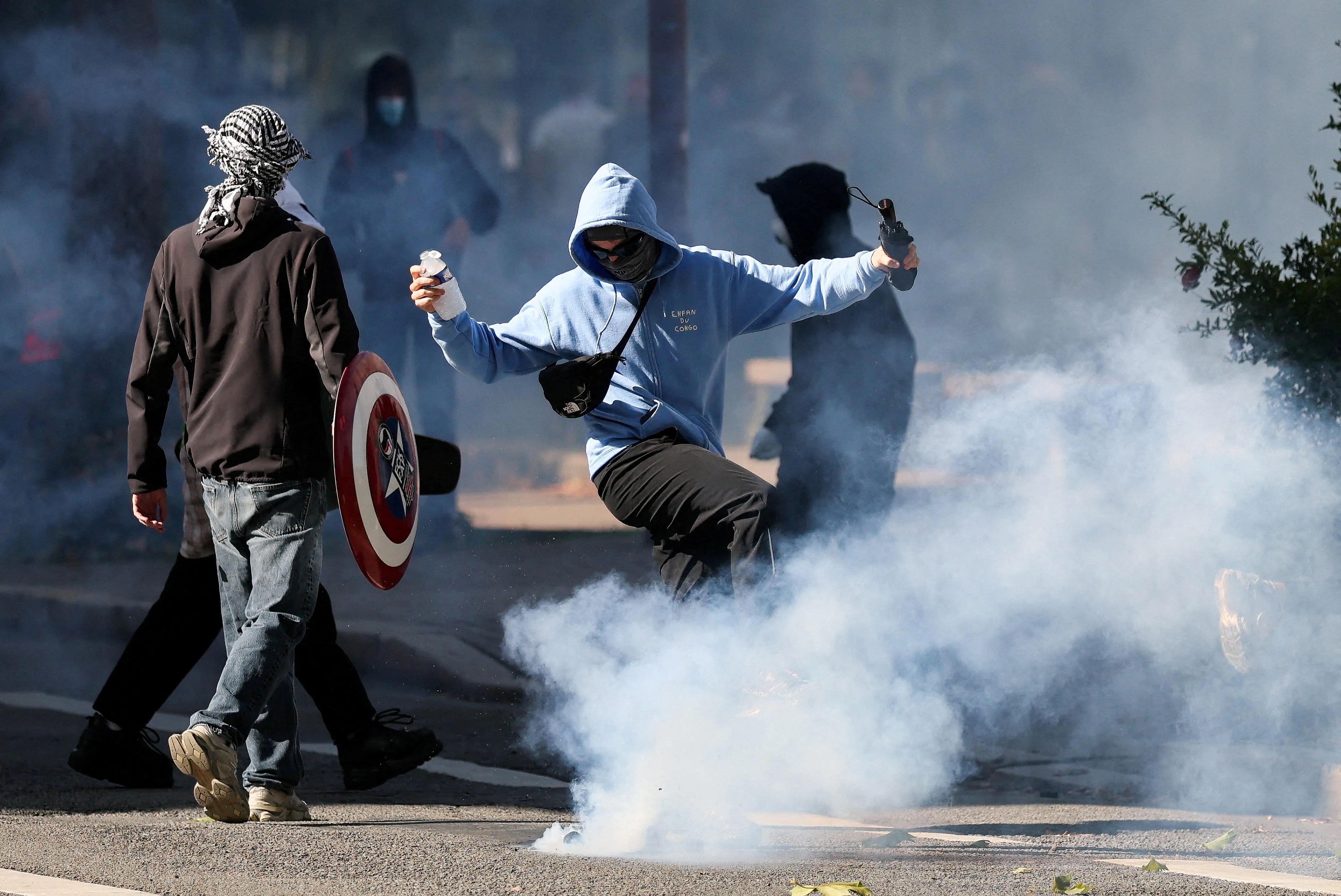 A person kicks a tear gas canister as French high school and university students attend a demonstration, part of a nationwide day of protests and blockades to demand better school conditions, in Nantes, France, October 8, 2026. REUTERS/Stephane Mahe      TPX IMAGES OF THE DAY