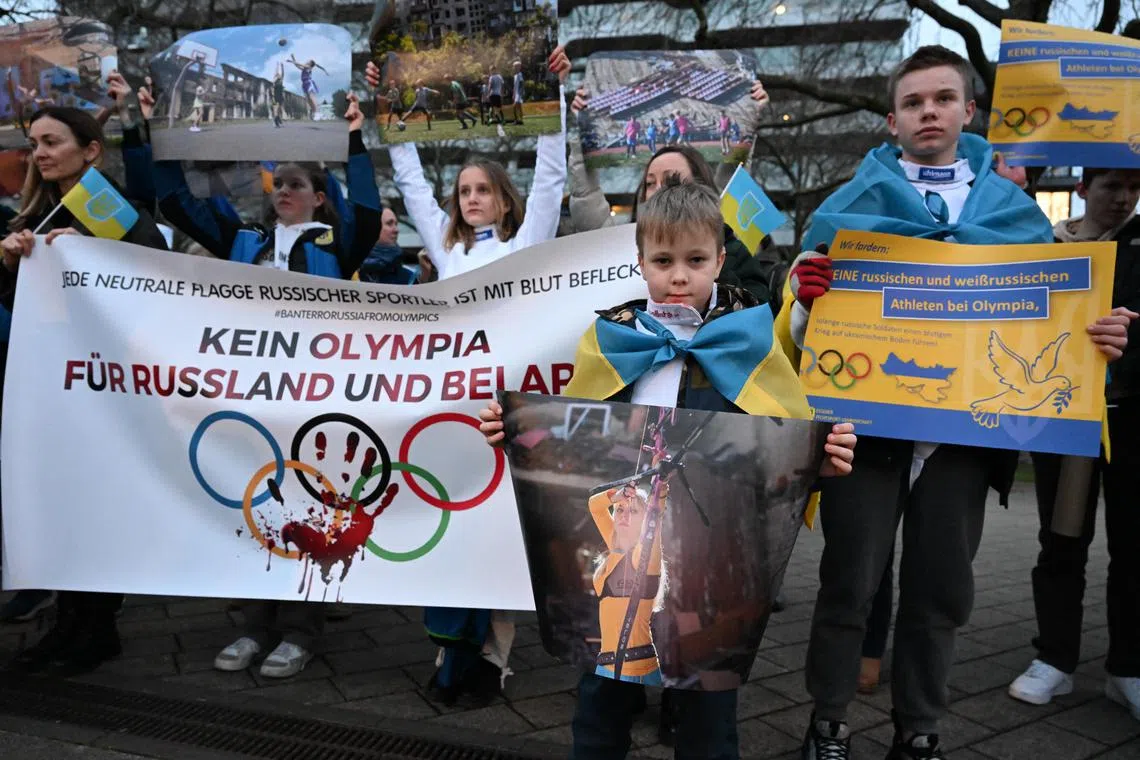 Ukrainian refugees protesting against any participation of Russian and Belarusian athletes at the Paris 2024 Olympic Games before the visit of IOC president Thomas Bach at the Ruhr Political Forum in Essen, Germany on Wednesday. 