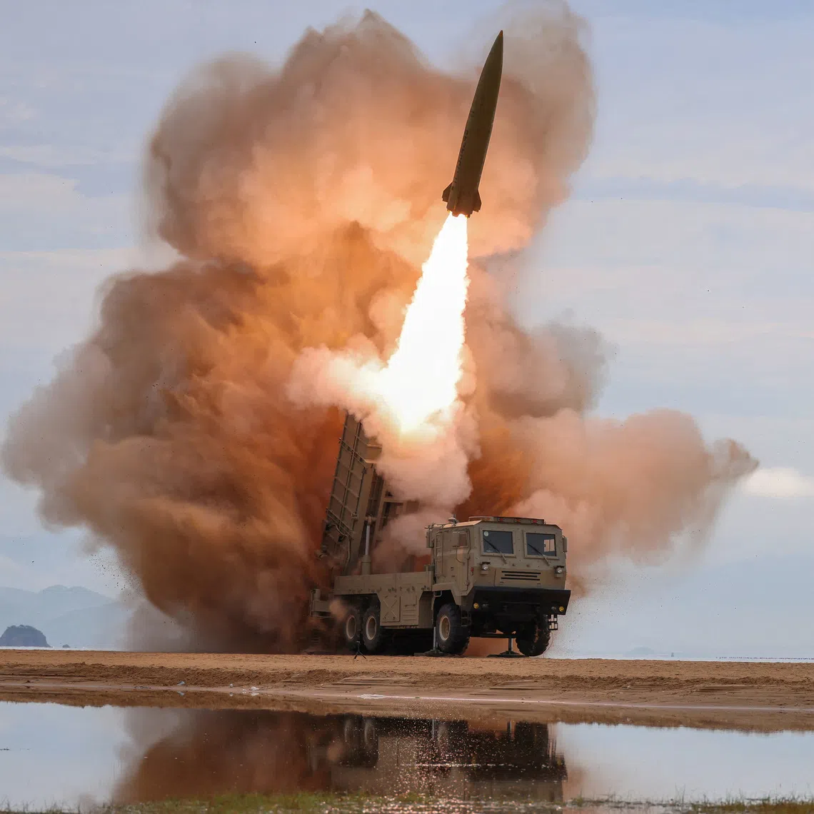 A rocket launcher fires a munition during tests overseen by North Korean leader Kim Jong Un in North Korea on June 25.