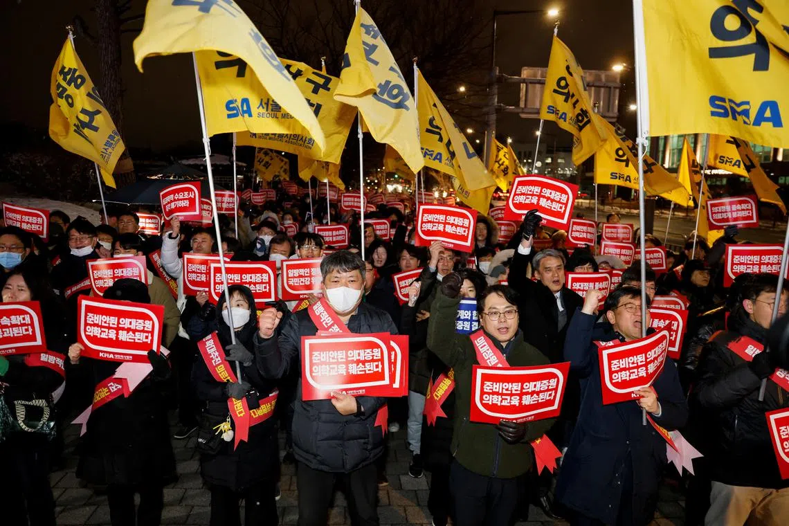 Doctors shout a slogan in a protest against a plan to admit more students to medical school, in front of the Presidential Office in Seoul, South Korea, February 22, 2024. REUTERS/Kim Soo-Hyeon