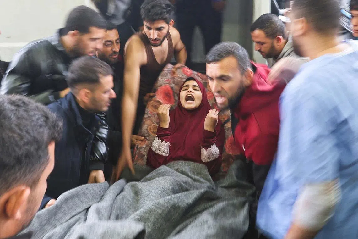 A wounded Palestinian is brought into Nasser hospital, following Israeli strikes on Ma'an school east of Khan Younis, amid the ongoing conflict between Israel and Palestinian Islamist group Hamas, in Khan Younis in the southern Gaza Strip, December 5, 2023. REUTERS/Ibraheem Abu Mustafa TPX IMAGES OF THE DAY