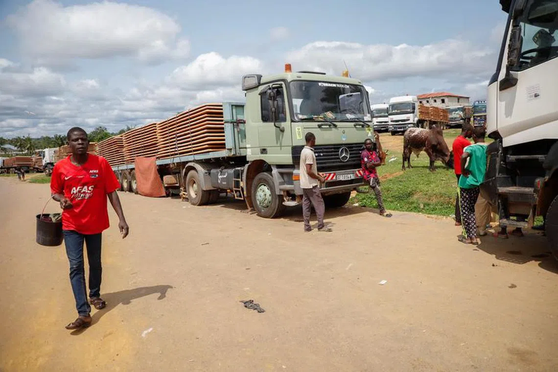 Truck drivers wait near their trucks carrying food, animals and industrial equipment because of the closure of the border after the coup in Gabon, in the border town of Kye-Ossi, Cameroon August 31, 2023. REUTERS/Desire Danga Essigue/File Photo