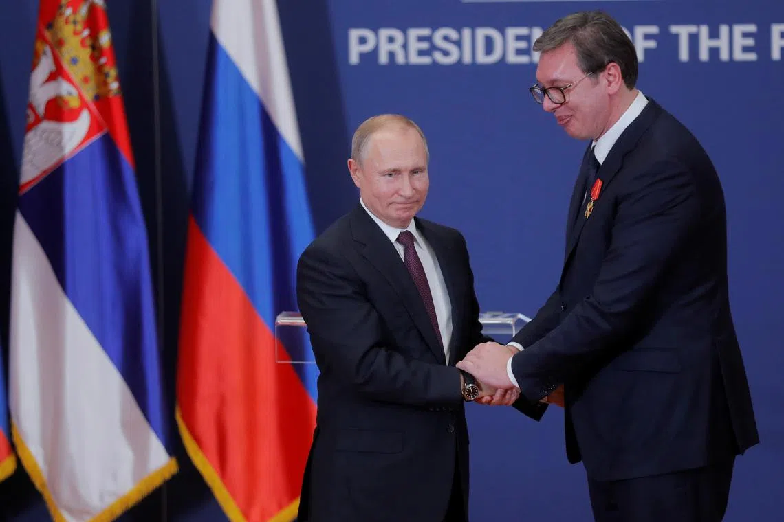 Russian President Vladimir Putin decorates Serbian President Aleksandar Vucic with an Order of Alexander Nevsky after their meeting in Belgrade, Serbia January 17, 2019. Maxim Shipenkov/Pool via REUTERS