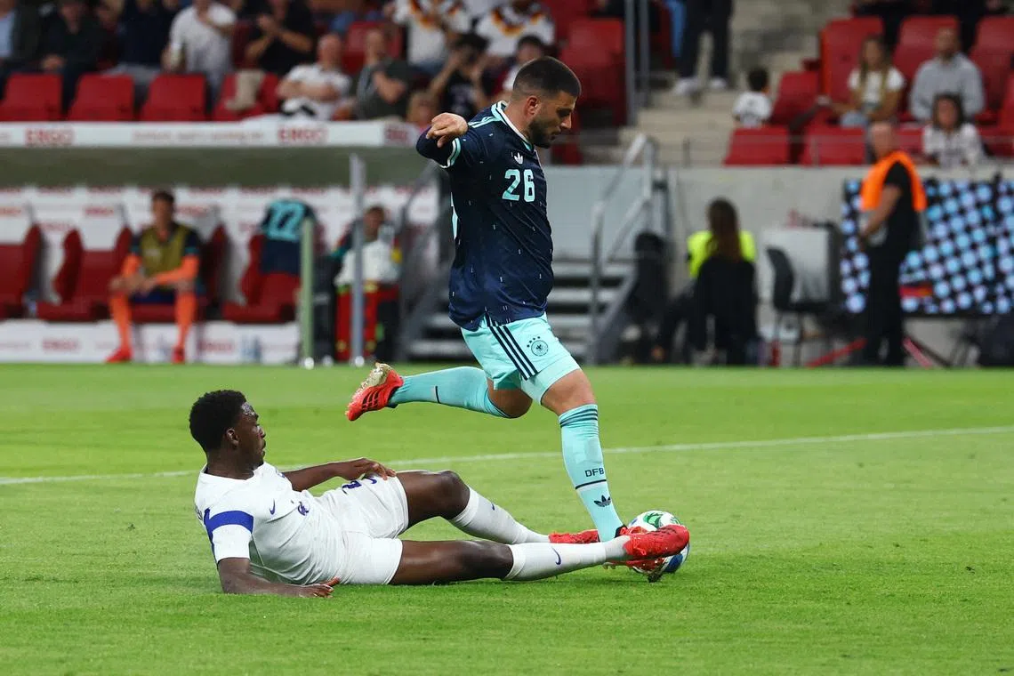 Germany's Deniz Undav scoring their third goal past a tackle from Finland defender Tony Miettinen in their 4-0 friendly win on May 31.