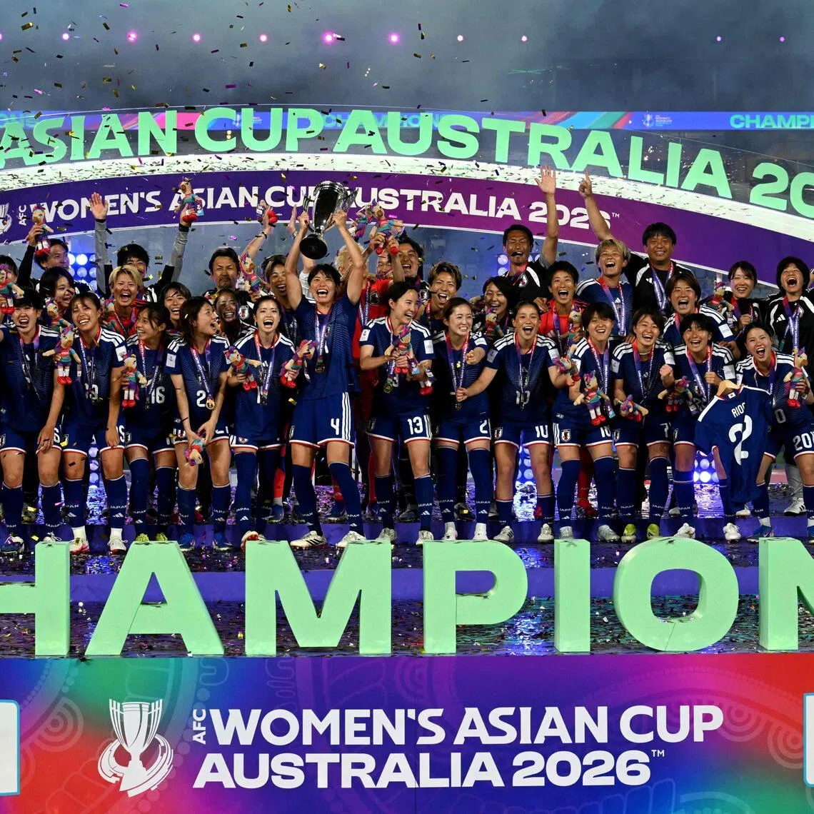 Japan's team celebrating with the trophy after beating hosts Australia 1-0 in the final of the 2026 Women’s Asian Cup at Stadium Australia in Sydney on March 21, 2026.