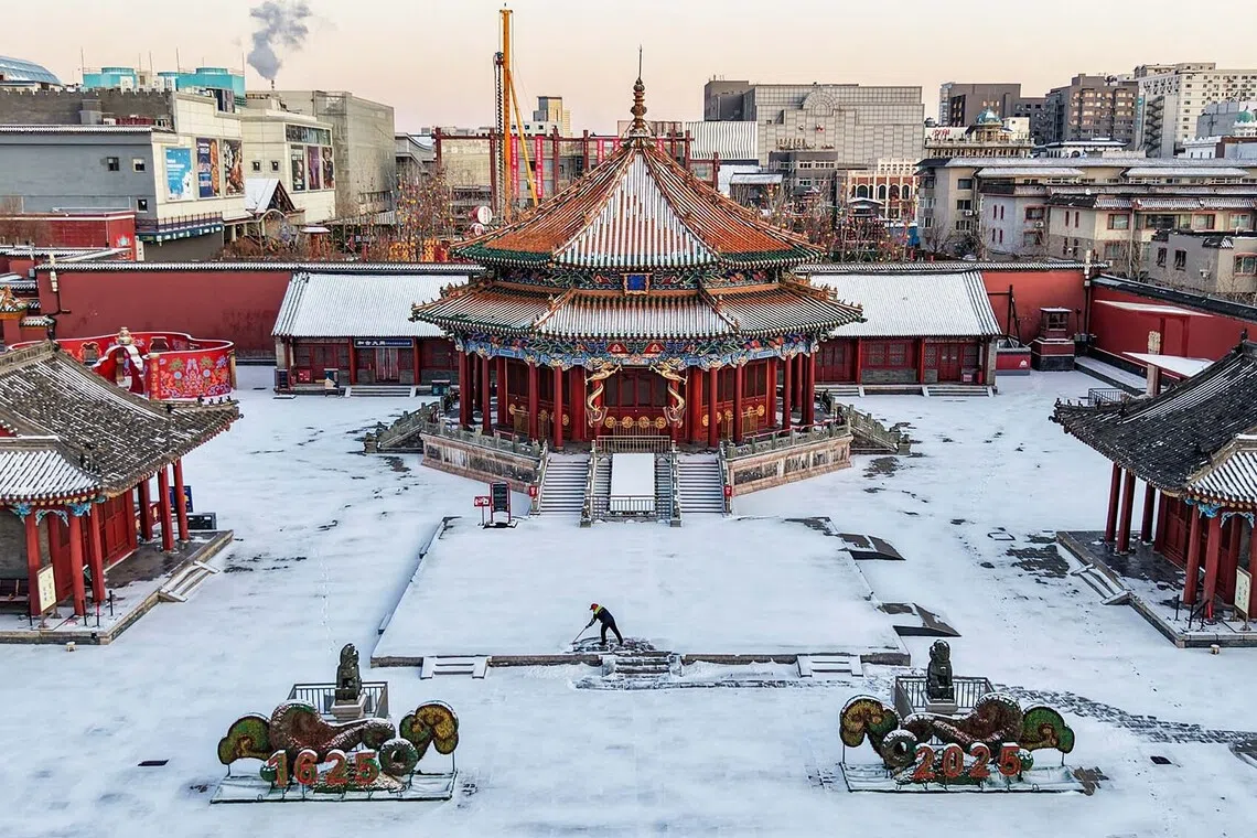 A man removing snow from a path at the Shenyang Imperial Palace after snowfall in Shenyang, northeast China's Liaoning province on Dec 11, 2025.