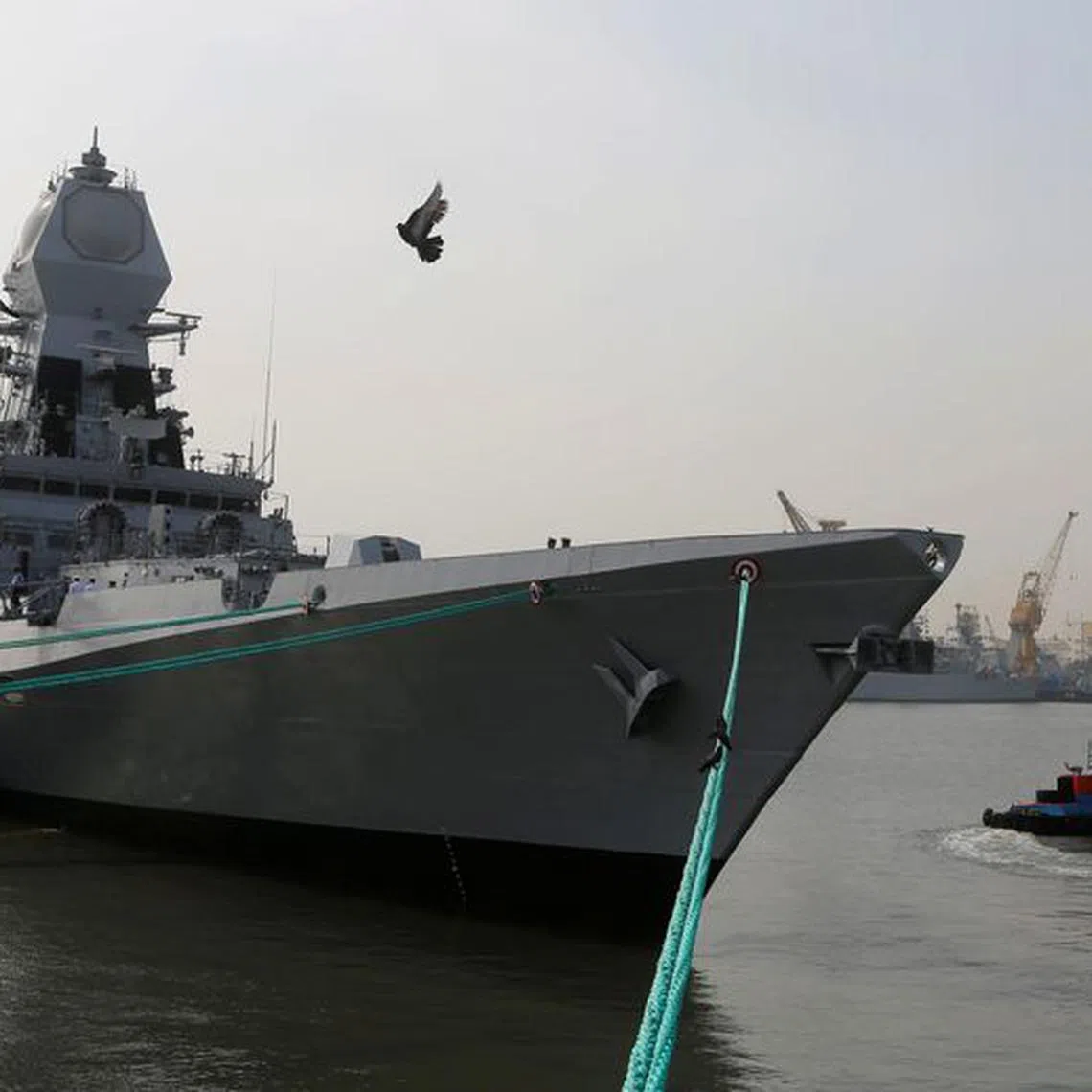 FILE PHOTO: A bird flies past the newly built INS Chennai, India’s third indigenously designed guided missile destroyer, ahead of its commissioning into the Navy in Mumbai, India November 18, 2016. REUTERS/Shailesh Andrade