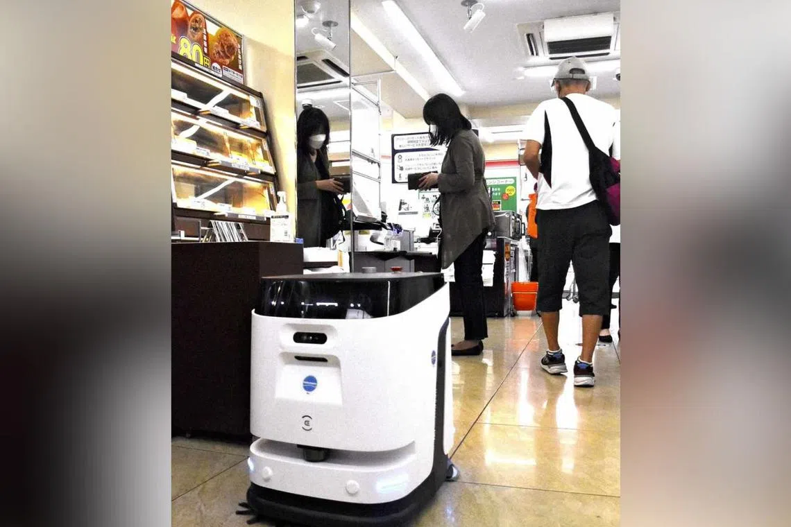 A robot cleans the floor at a 7-Eleven store in Tokyo's Arakawa War on Sept 9, 2025.