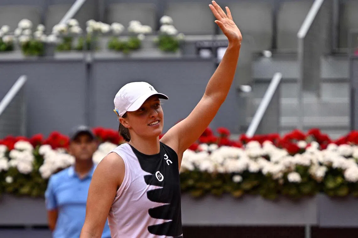 Poland's Iga Swiatek celebrates after winning her match against Bernarda Pera, of the US.