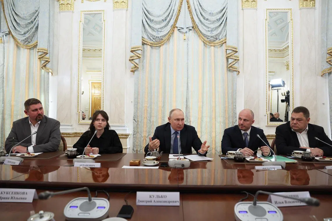 Russian President Vladimir Putin (centre) chairs a meeting with Russian war journalists in Moscow.