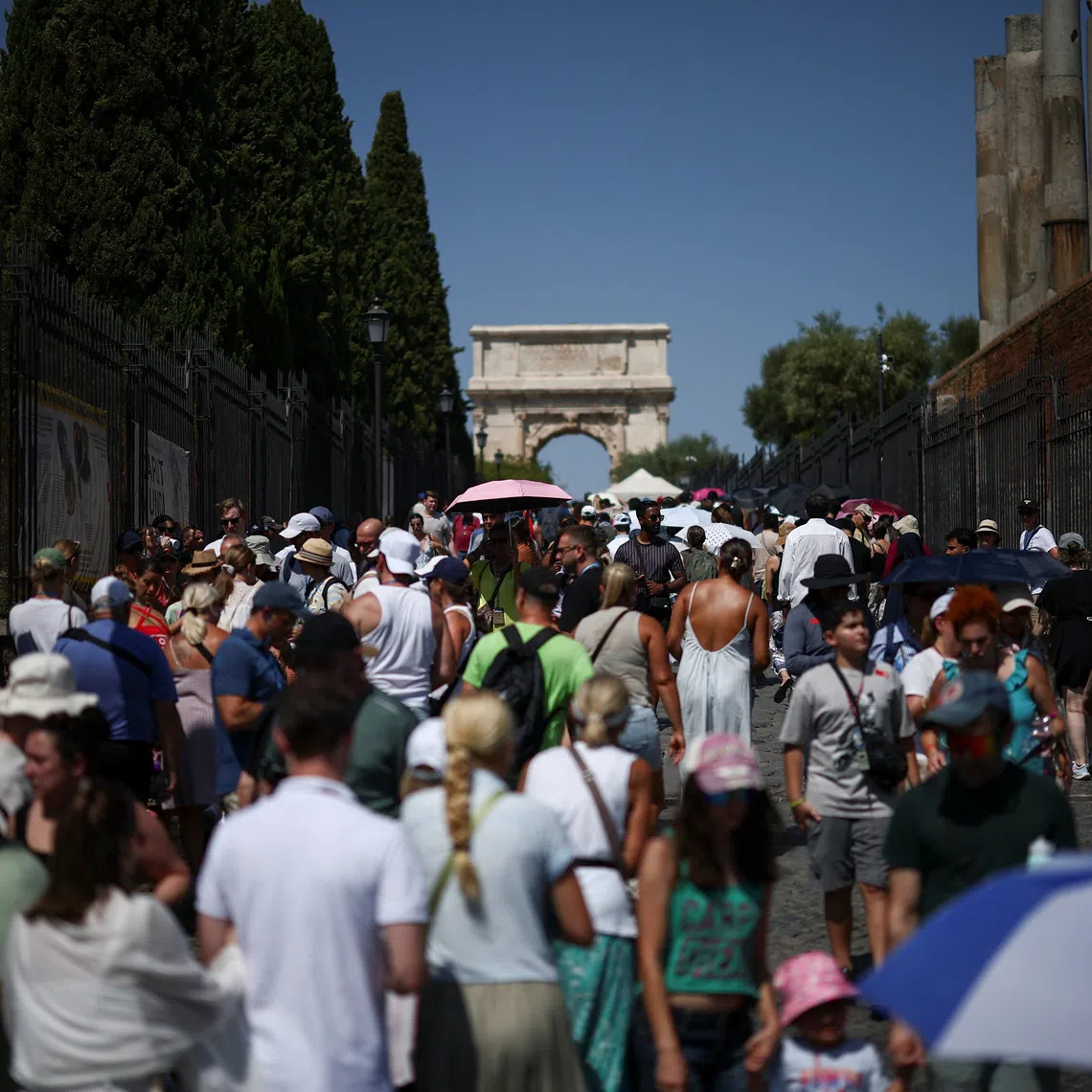 People walk along the \"Via Sacra\" (Sacred Street) as temperatures near 40 degrees Celsius during a heatwave, in Rome, Italy, August 11, 2026. REUTERS/Guglielmo Mangiapane