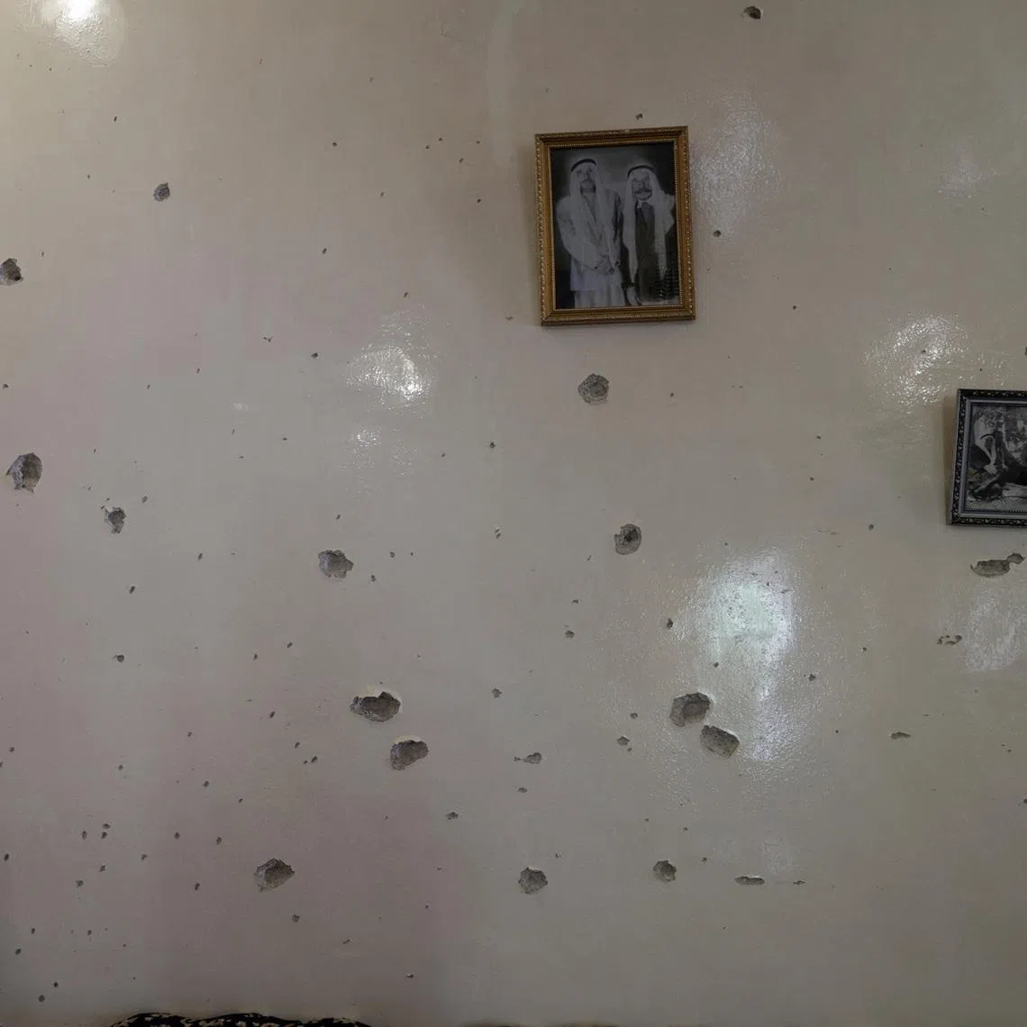 FILE PHOTO: A wall is pockmarked by bullet holes inside the Saraya family house, following sectarian violence in Syria's Sweida province, where government forces were sent to quell local clashes between Druze armed factions and Bedouin tribal fighters, in the predominantly Druze city of Sweida, Syria, July 25, 2025. REUTERS/Khalil Ashawi/File Photo