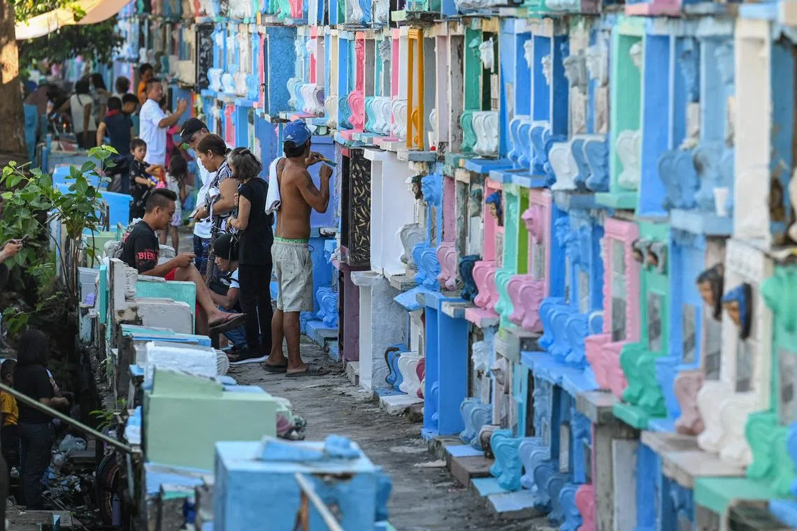 People visit tombs at the Manila North Cemetery in Manila.