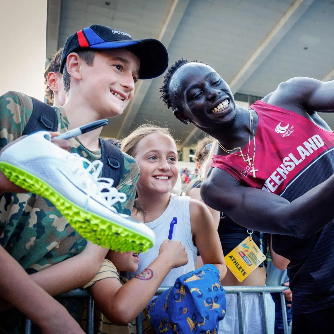 Gout Gout of Australia poses with fans after winning the 100m final of the Australian Athletics Junior Championships on April 18.