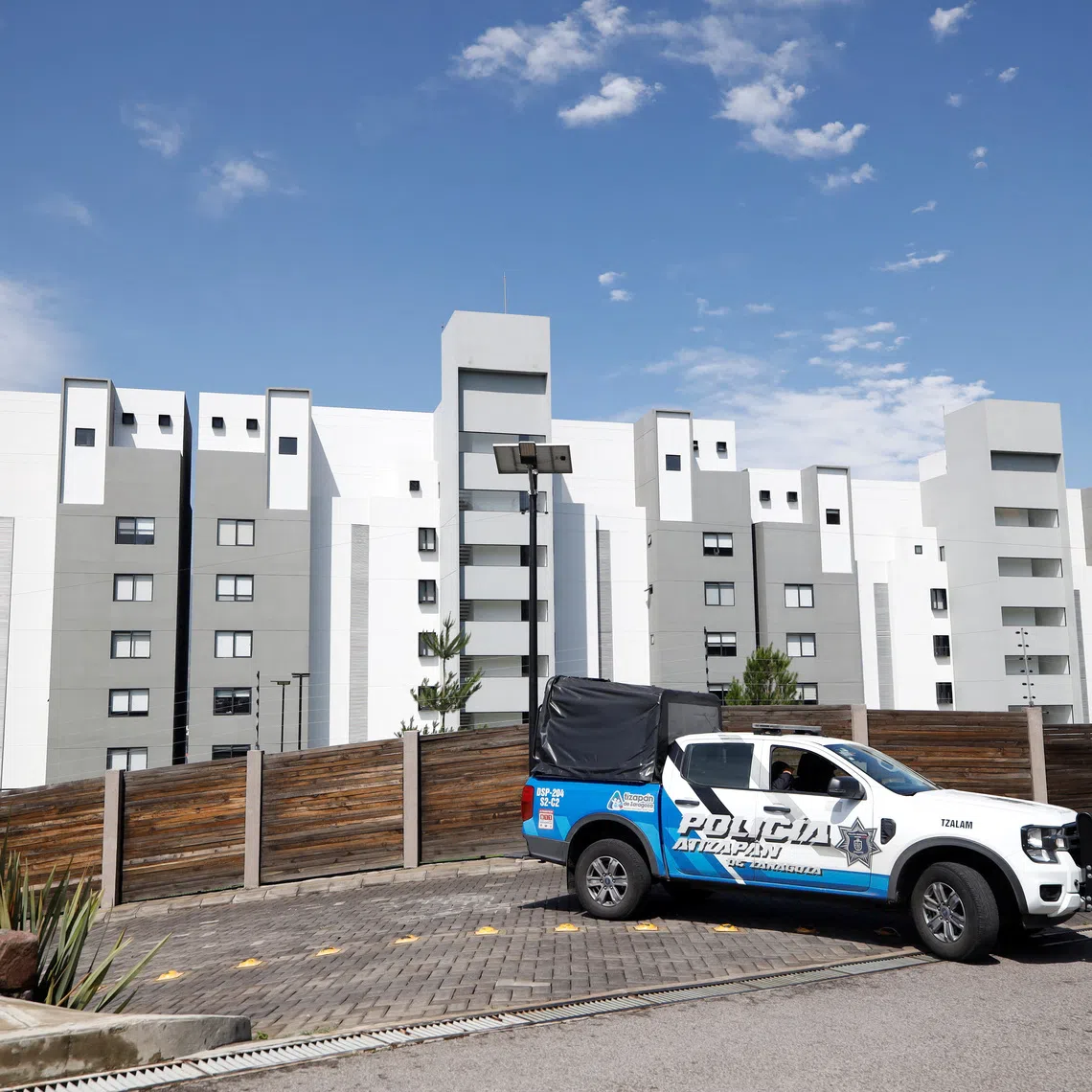 Municipal police officers guard the apartment complex where Jonathan Melendez, a Mexican musician who played keyboard for the indie rock band Camilo Septimo, his pregnant wife, their 3-year-old daughter, a domestic worker and the family's dog were found tied up and shot dead in a penthouse in an upscale residential development in Atizapan de Zaragoza, on the outskirts of Mexico City, Mexico, September 3, 2026. REUTERS/Luis Cortes