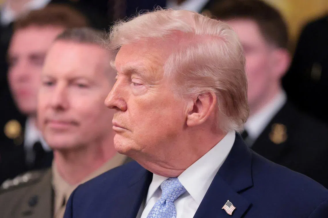 U.S. President Donald Trump looks on during a presentation of the Commander-in-Chief's trophy to the U.S. Navy Midshipmen football team of the United States Naval Academy, at the White House in Washington, D.C., U.S., March 20, 2026. REUTERS/Kylie Cooper