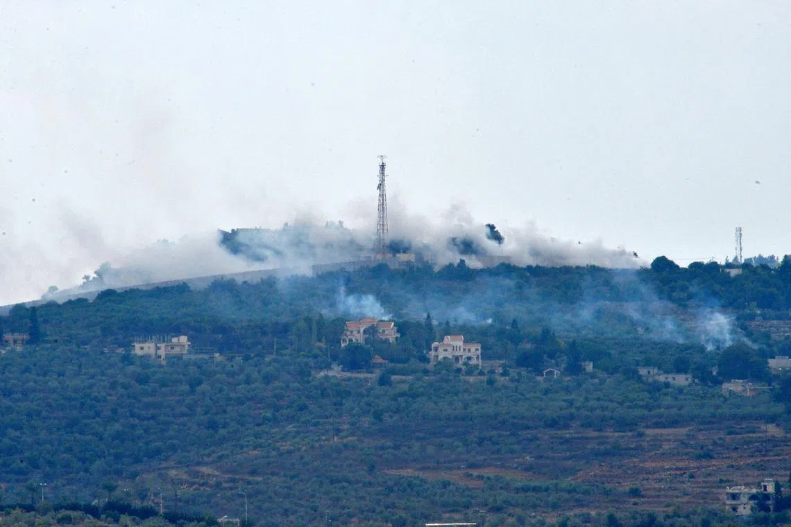 Smoke rises from positions on a hill after Israeli shelling on the outskirts of Dhayra village, near the Lebanese-Israeli border, Lebanon, on Oct 11, 2023.