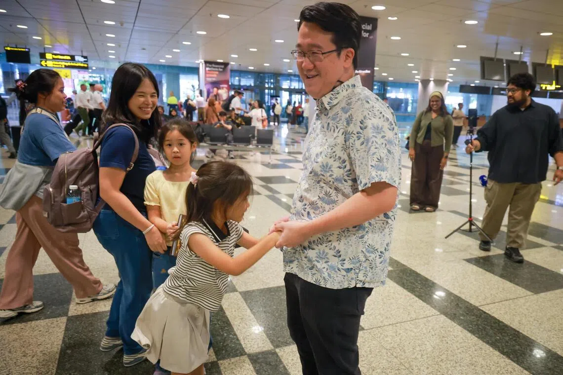 Albert Susilo (right) returned to the airport just an hour after arriving from a 16-hour journey to welcome his wife Jenifer Kosasih (second from left), and children back from Jakarta.
