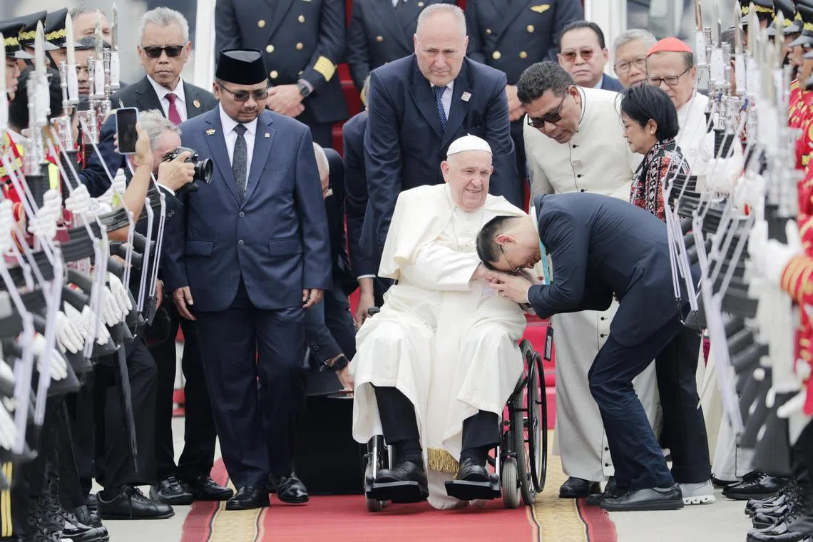 Pope Francis is welcomed during his arrival at Soekarno-Hatta International Airport in Tangerang, Banten, on the outskirts of Jakarta on Sept 3.