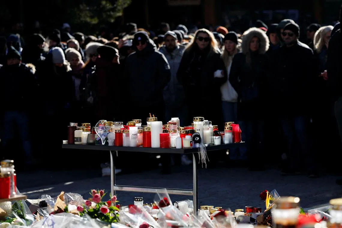 People gather around a makeshift memorial outside the \"Le Constellation\" bar, after a deadly fire and explosion during a New Year's Eve party, in the upscale ski resort of Crans-Montana, in southwestern Switzerland, January 4, 2026. REUTERS/Lisa Leutner