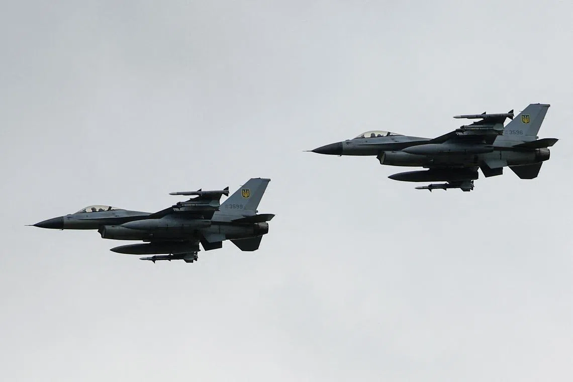 Ukrainian F-16 fighting aircrafts are seen in the air during marking the Day of the Ukrainian Air Forces, amid Russia's attack on Ukraine, in an undisclosed location, Ukraine August 4, 2024. REUTERS/Valentyn Ogirenko