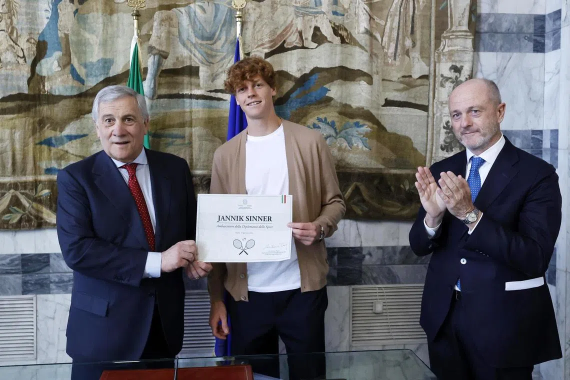 Italian Foreign Minister Antonio Tajani and Jannik Sinner pose with a certificate calling the tennis player "ambassador of sport's diplomacy" at the foreign ministry in Rome on Jan 31, 2024.
