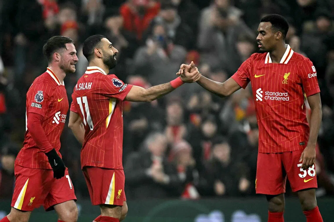 Liverpool's Mohamed Salah (second from right) secured the win, scoring his team's third goal.