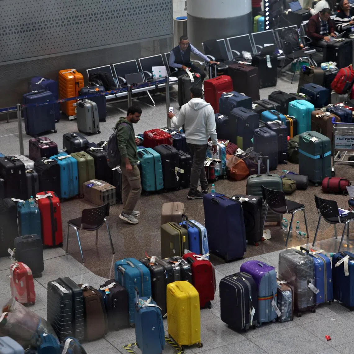 IndiGo staff tagging stranded bags and belongings of passengers following large-scale flight disruptions at New Delhi's Indira Gandhi International Airport on Dec 8.