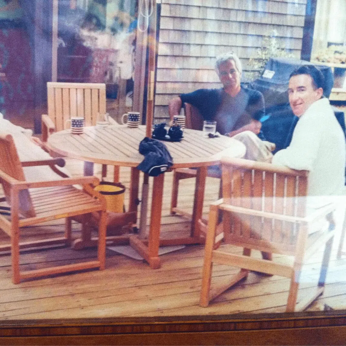 Andrew Mountbatten-Windsor and Lord Peter Mandelson are seen wearing bathrobes seated alongside late financier and convicted sex offender Jeffrey Epstein, in an undated photograph released by the Department of Justice in Washington, D.C., U.S., as part of a trove of documents from its investigations into Epstein. U.S. Justice Department/Handout via REUTERS THIS IMAGE HAS BEEN SUPPLIED BY A THIRD PARTY. 