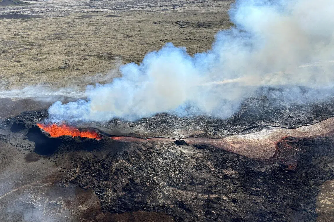 FILE PHOTO: Lava spurts and flows after the eruption of a volcano in the Reykjanes Peninsula, Iceland, July 12, 2023.
