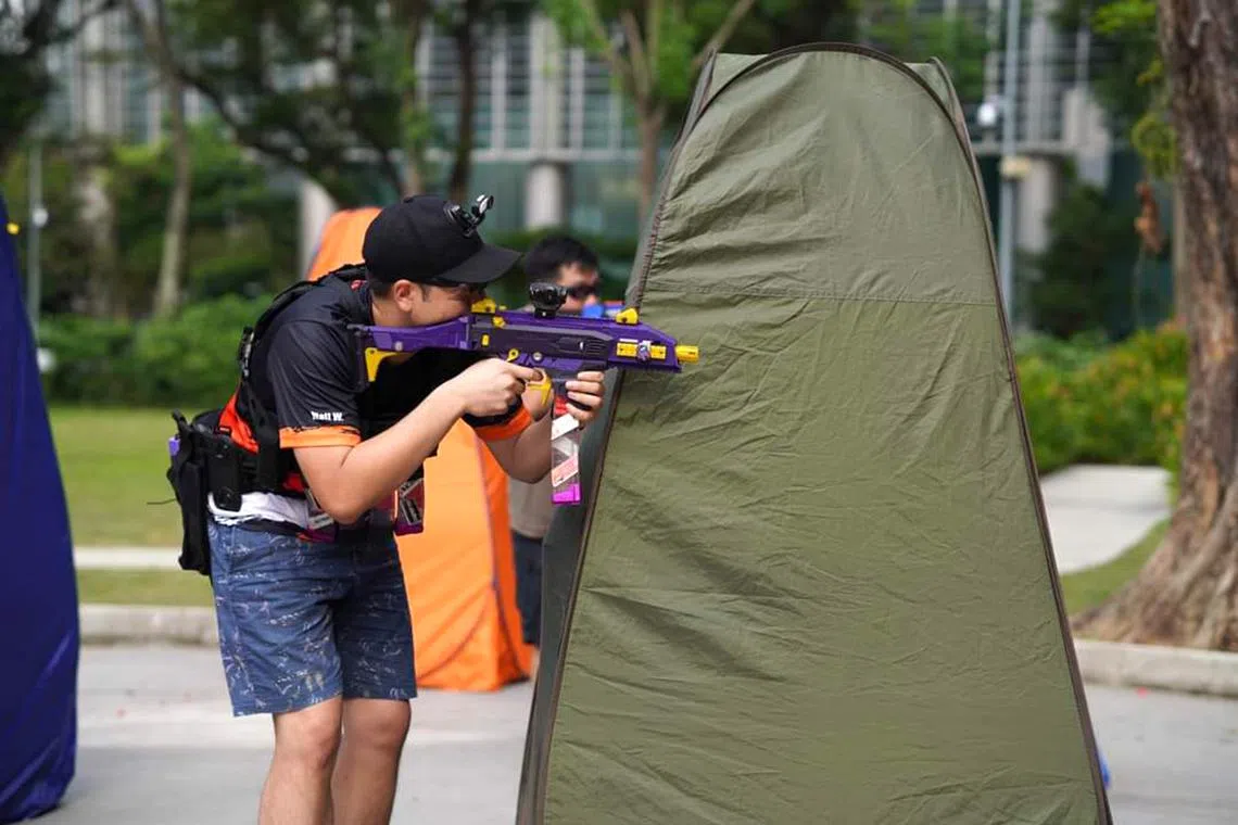 Mr Matthew Wong, a regular NerfSG participant and Nerf hobbyist, takes aim with his 3D printed nerf blaster. 