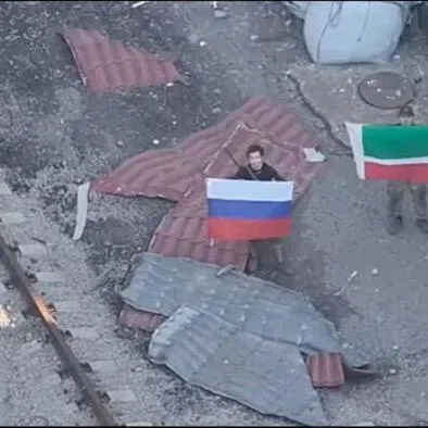 A drone view on July 3 showing soldiers holding up a Russian and Chechen Republic flags as the Russian forces reportedly took control of Kostiantynivka in the Donetsk region, Ukraine.