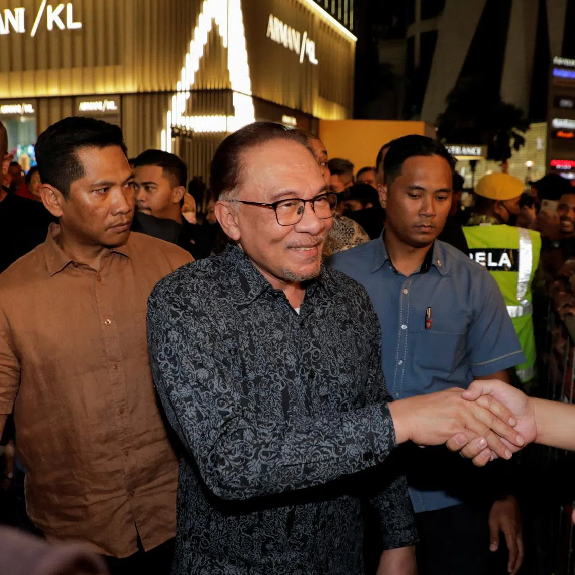 Malaysia Prime Minister Anwar Ibrahim greets people as he attends a premiere show of Anwar: The Untold Story, a film based on the period in Anwar's life when he became finance minister from 1991 until he was fired from the Cabinet in 1998, in Kuala Lumpur, Malaysia May 8, 2023. REUTERS/Hasnoor Hussain