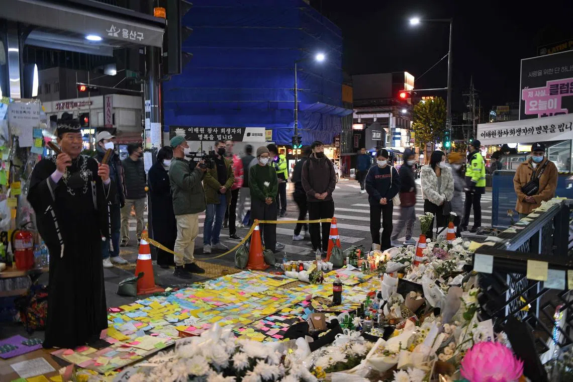 A Japanese monk (left) chants near a makeshift memorial for the victims of in the Halloween crowd crush in Itaewon, on Nov 5.