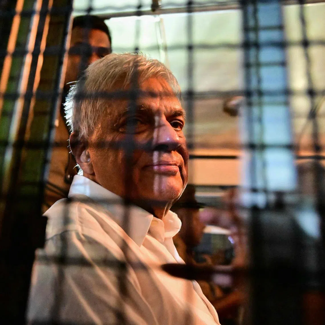 Sri Lanka's former president Ranil Wickremesinghe looks on as he sits in a prison bus in Colombo on Aug 22, 2025.