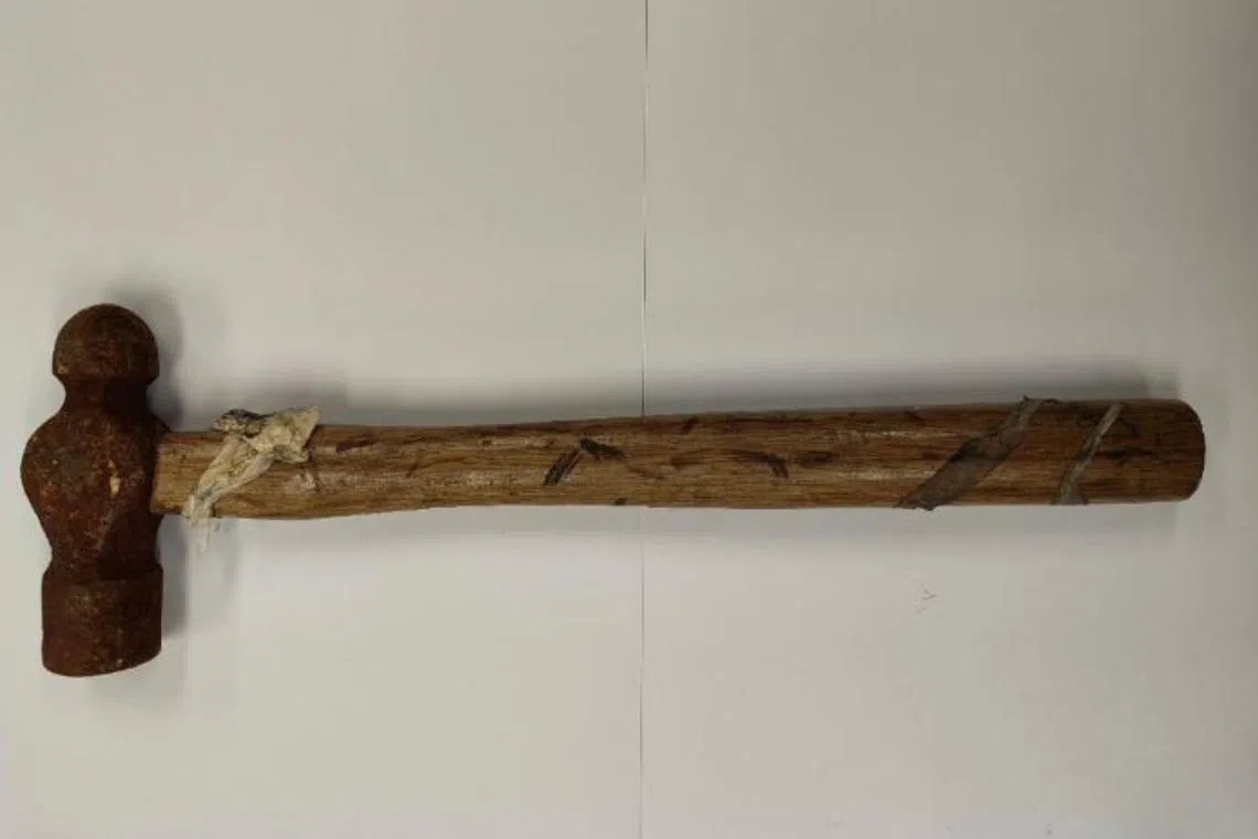 The man allegedly used the hammer to threaten the woman by banging on her door and damaging it.