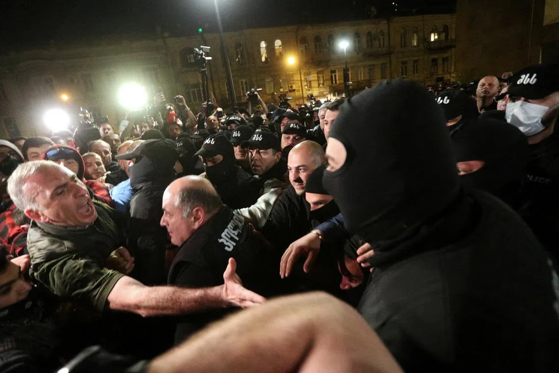 FILE PHOTO: Member of the Georgian Parliament Aleko Elisashvili shouts in front of law enforcement officers during a protest against a draft bill on \"foreign agents\" in Tbilisi, Georgia April 17, 2024. REUTERS/Irakli Gedenidze/File Photo