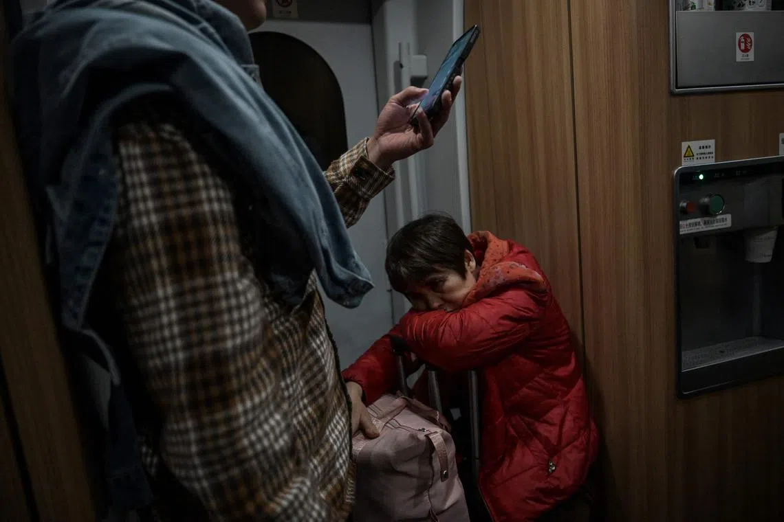 Passengers are seen on a high speed train at a railway station in Shenzhen, in southern China’s Guangdong province on January 26, 2025, amid peak travel ahead of the Lunar New Year of the Snake which falls on January 29. (Photo by JADE GAO / AFP)