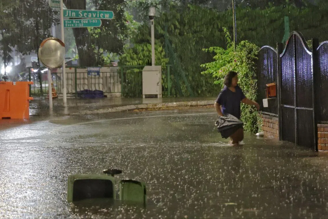 A resident navigating a flooded section of Jalan Seaview on Jan 10, 2025.