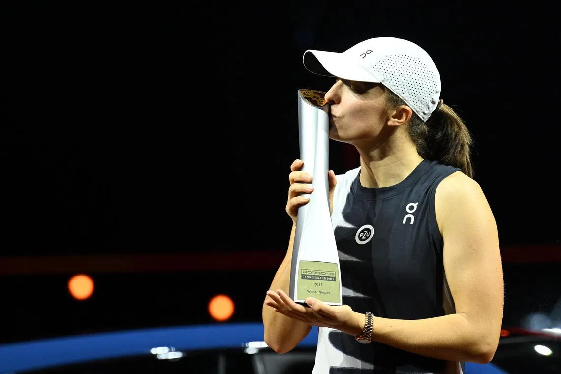 Iga Swiatek celebrating with the trophy after her 6-3, 6-4 Stuttgart Open final win over Aryna Sabalenka.