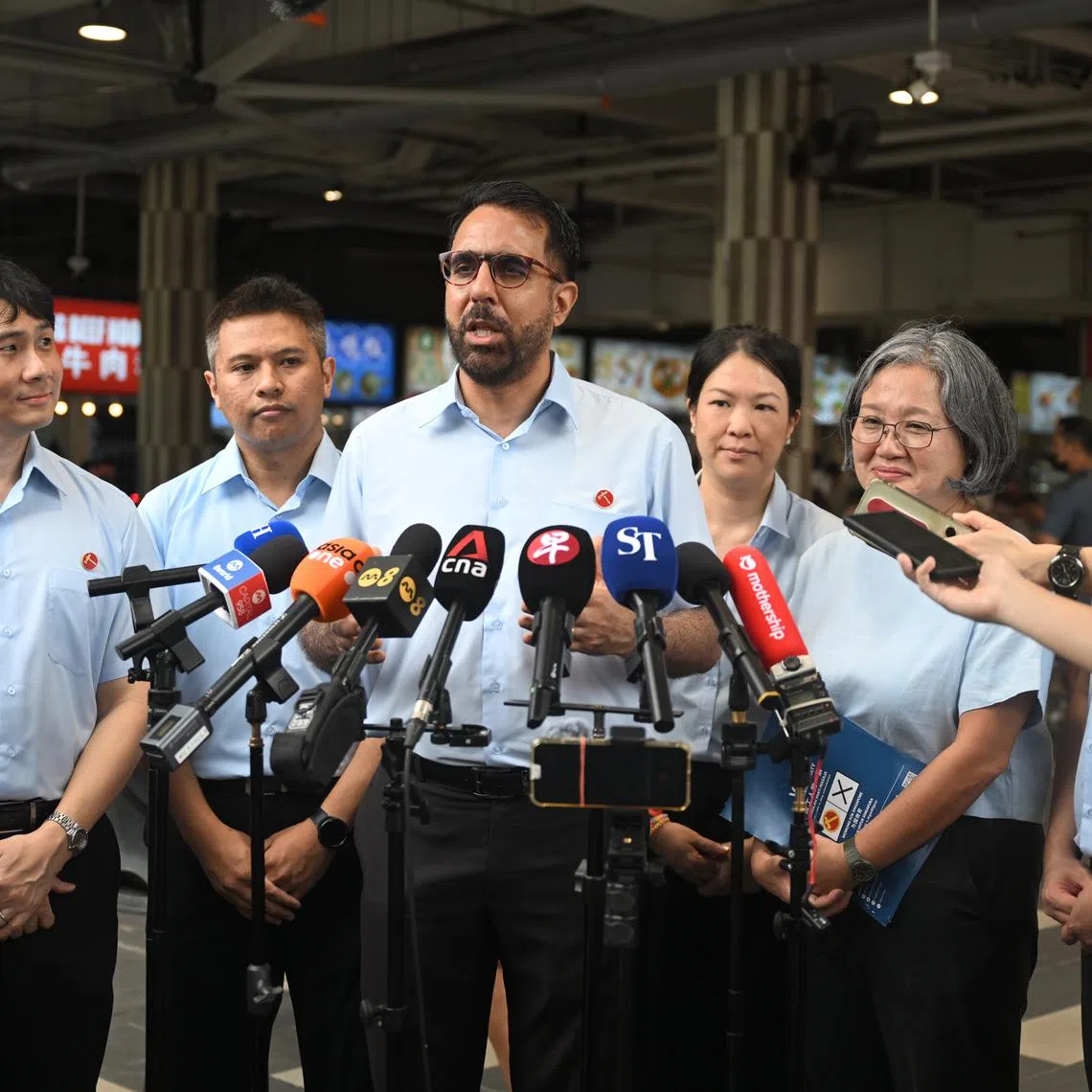 WP chief Pritam Singh (third from left) speaking to reporters after a walkabout in Sengkang on April 24. With him are WP chair Sylvia Lim (second from right) and the party's Sengkang GRC candidates (from left) Jamus Lim, Abdul Muhaimin Abdul Malik, He Ting Ru and Louis Chua.