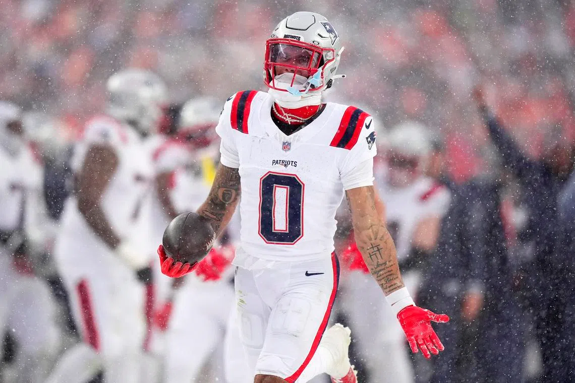 Jan 25, 2026; Denver, CO, USA; New England Patriots cornerback Christian Gonzalez (0) reacts after an interception against the Denver Broncos  during the second half in the 2026 AFC Championship Game at Empower Field at Mile High. Mandatory Credit: Ron Chenoy-Imagn Images