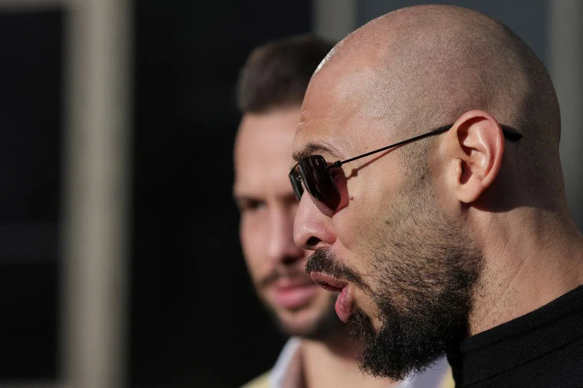 Andrew Tate, next to his brother Tristan Tate, talks to media representatives after exiting the Bucharest courthouse, in Bucharest, Romania, January 9, 2025. Inquam Photos/Octav Ganea via REUTERS/File Photo