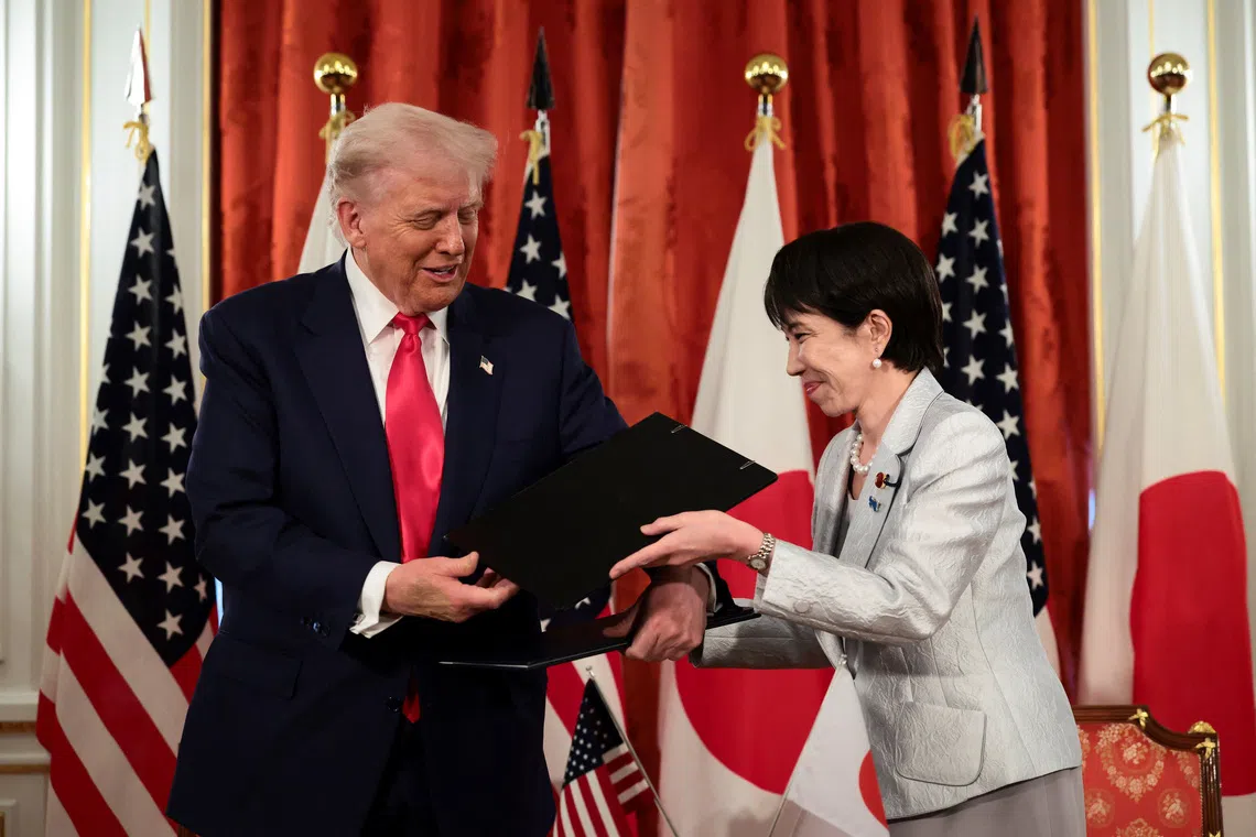 U.S. President Donald Trump and Japanese Prime Minister Sanae Takaichi hold signed documents regarding securing the supply of critical minerals and rare earths, at a bilateral meeting at Akasaka Palace in Tokyo, Japan, October 28, 2025. REUTERS/Evelyn Hockstein