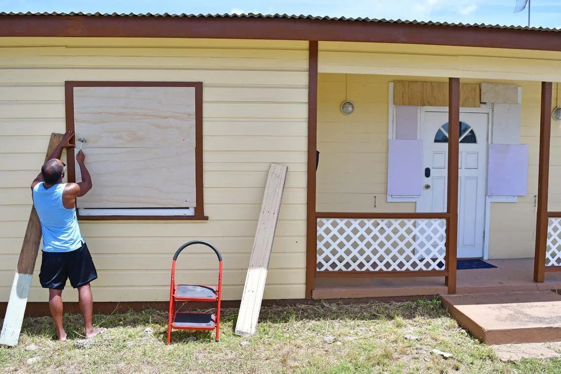 A man boards up a house ahead of the arrival of Hurricane Beryl in Bridgetown, Barbados June 30, 2024. REUTERS/Nigel R Browne